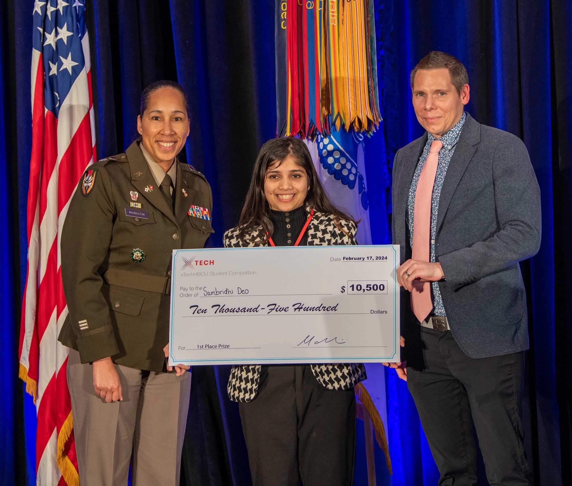 Sam with Army officials at her xTech first-place award